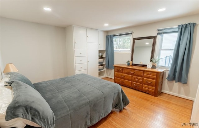 bedroom with recessed lighting, light wood-style flooring, and baseboards