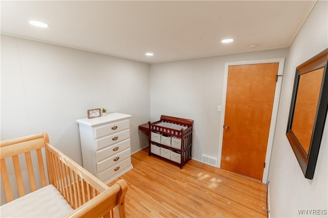 bedroom with light wood-style flooring, recessed lighting, and visible vents