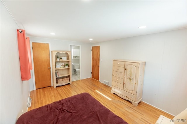 bedroom featuring visible vents, recessed lighting, ensuite bathroom, and wood finished floors