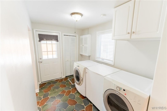 laundry area with washer and dryer, cabinet space, and a wealth of natural light