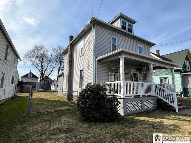 exterior space featuring a yard, a porch, and fence