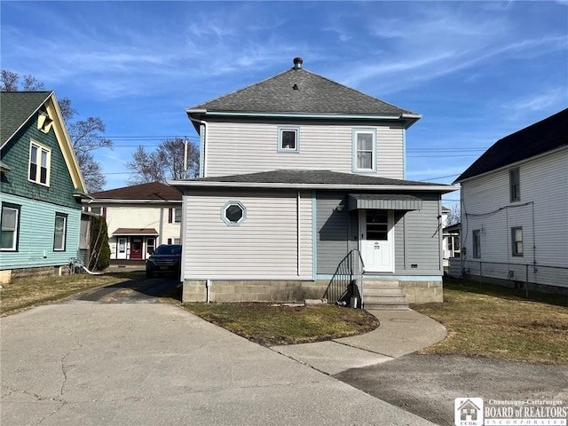 american foursquare style home with roof with shingles