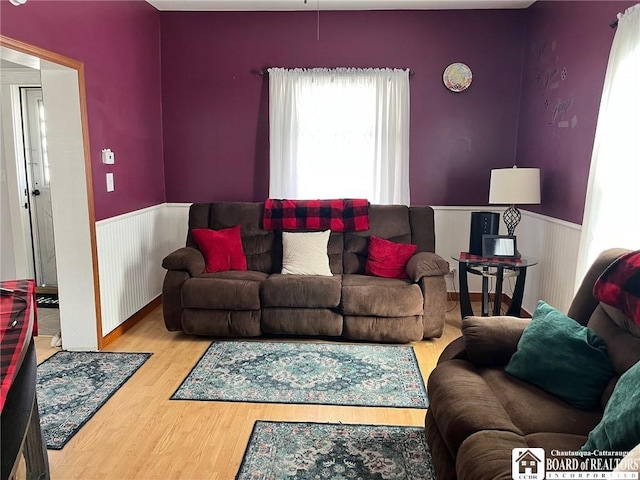 living room featuring wood finished floors and wainscoting