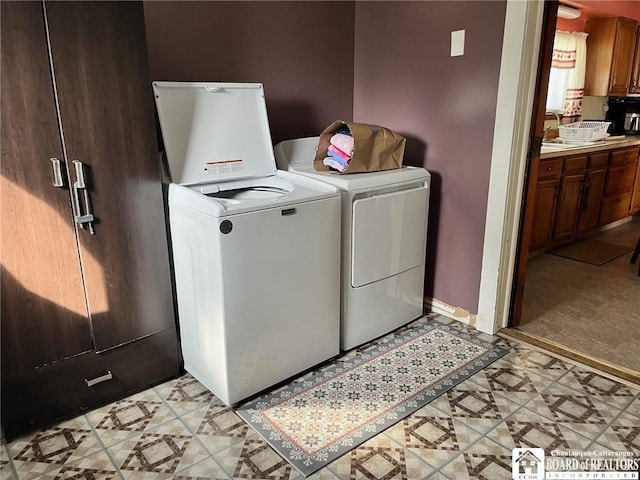 laundry room with laundry area, light floors, and separate washer and dryer