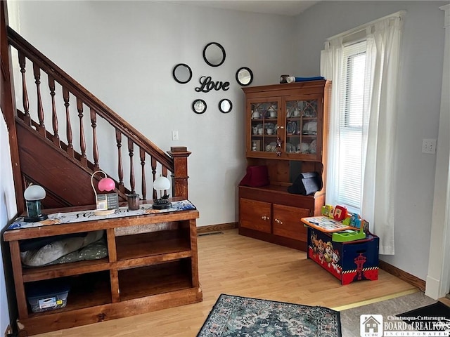 staircase with wood finished floors and baseboards