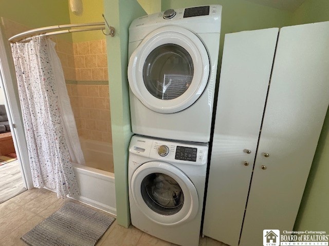 clothes washing area featuring laundry area and stacked washer and dryer