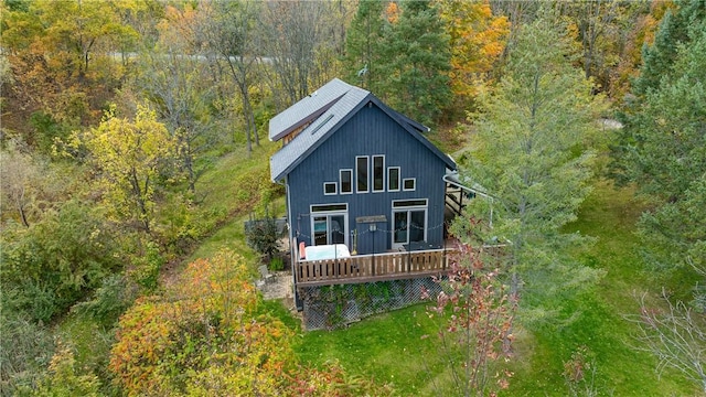 back of property featuring a wooded view