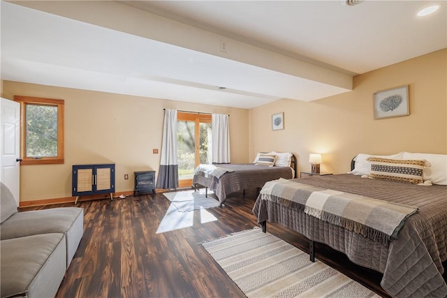 bedroom featuring baseboards, wood finished floors, and access to outside