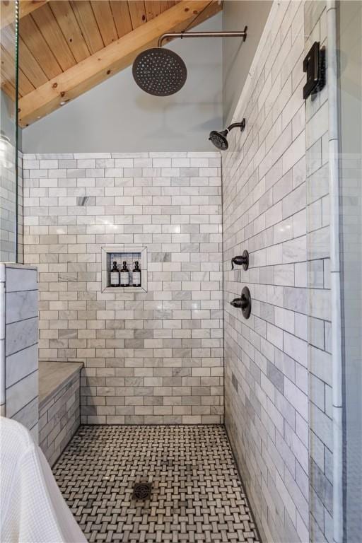 bathroom with wooden ceiling, vaulted ceiling with beams, and a tile shower