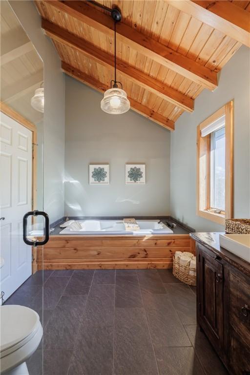 bathroom with wood ceiling, toilet, vaulted ceiling with beams, and a bath