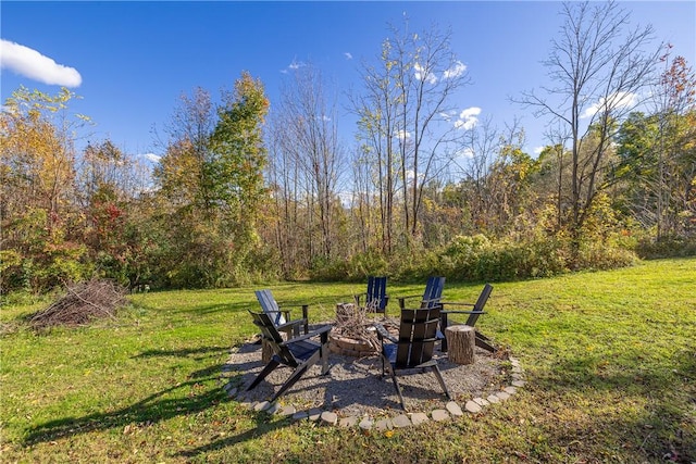 view of yard with a fire pit and a forest view