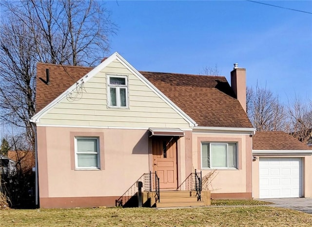 view of front facade featuring stucco siding, a chimney, a shingled roof, a garage, and aphalt driveway