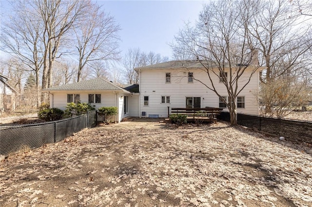 back of property with a deck and a fenced backyard