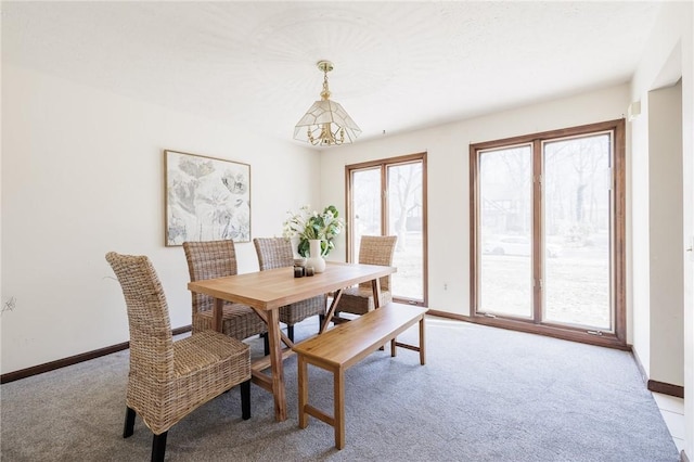 dining area with light colored carpet and baseboards