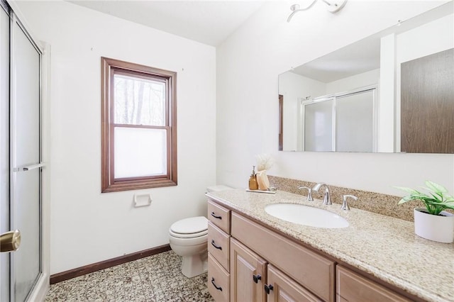 bathroom featuring an enclosed shower, baseboards, toilet, and vanity