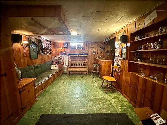 interior space featuring tile patterned floors and wood walls