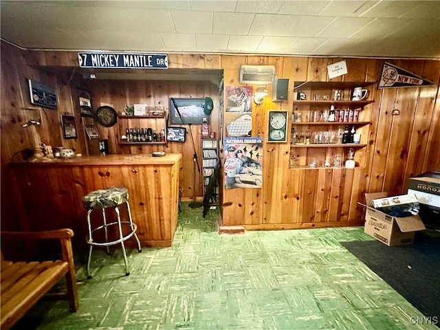 bar featuring tile patterned floors, a dry bar, and wooden walls