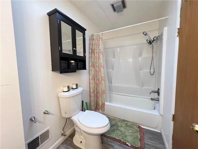 bathroom featuring visible vents, toilet, wood finished floors, and shower / bath combo