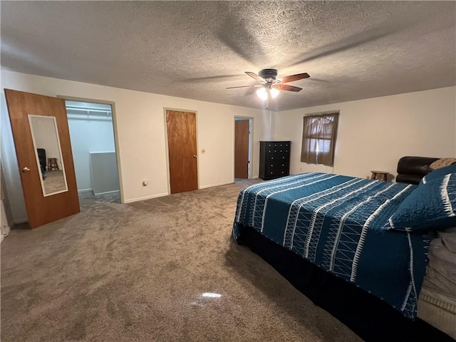 carpeted bedroom with a textured ceiling and ceiling fan