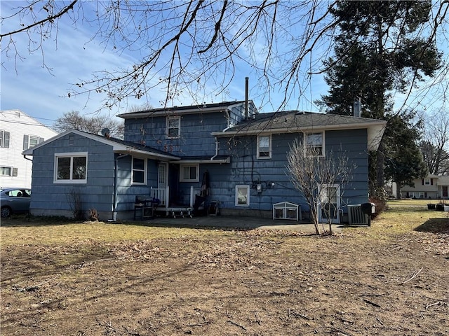 back of property with central AC