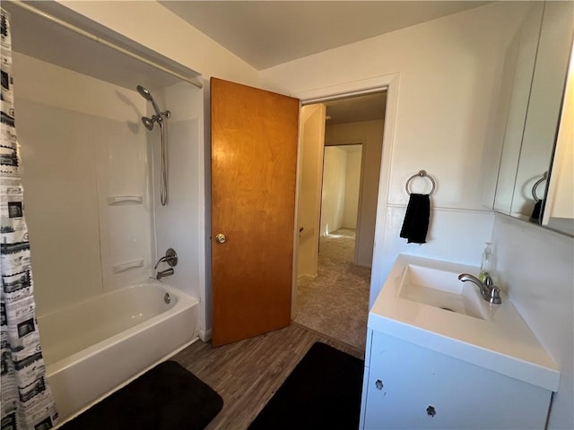 bathroom with shower / bathtub combination with curtain, wood finished floors, and vanity