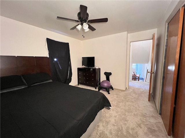 bedroom featuring light carpet and ceiling fan