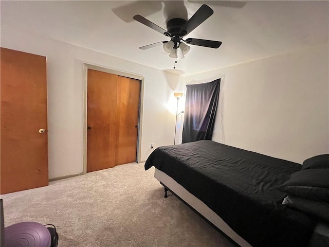 bedroom featuring a closet, a ceiling fan, and carpet