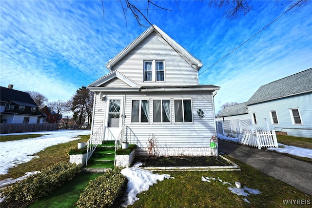 view of front of home featuring fence