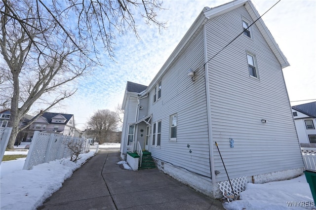 view of snowy exterior featuring fence