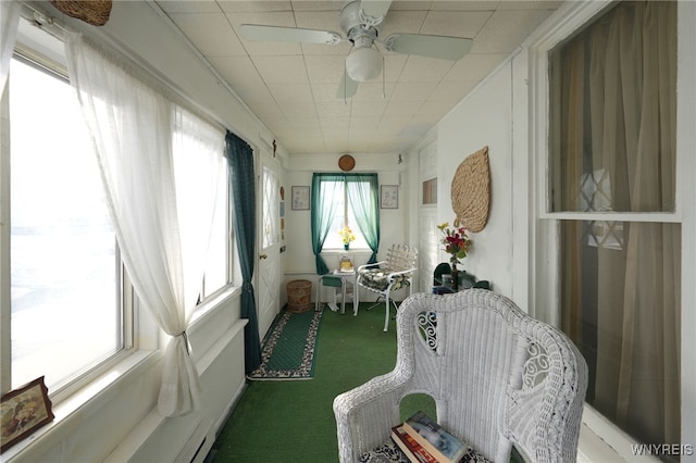 sunroom with a ceiling fan