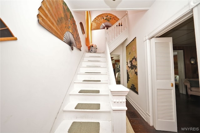 stairs featuring baseboards and wood finished floors