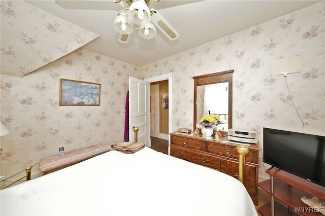 bedroom with wallpapered walls and ceiling fan