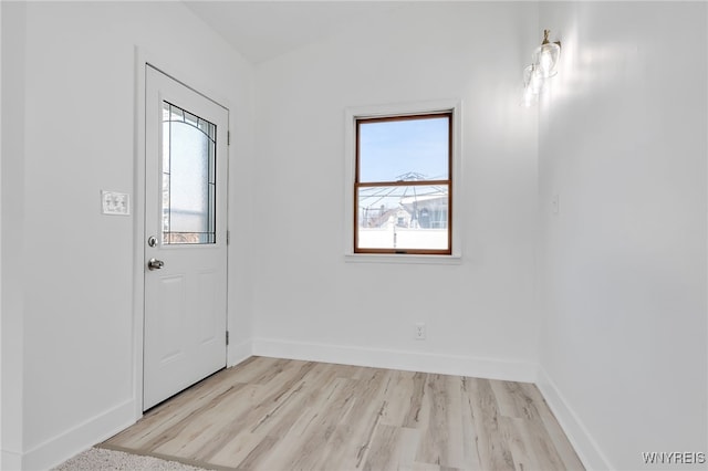 entryway featuring light wood-style flooring and baseboards