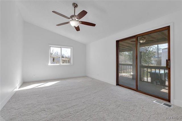 spare room with visible vents, a ceiling fan, lofted ceiling, and carpet