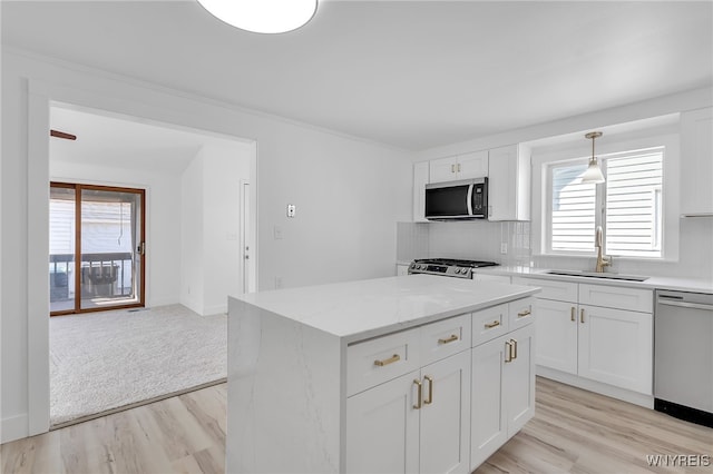 kitchen featuring a sink, stainless steel appliances, plenty of natural light, and tasteful backsplash