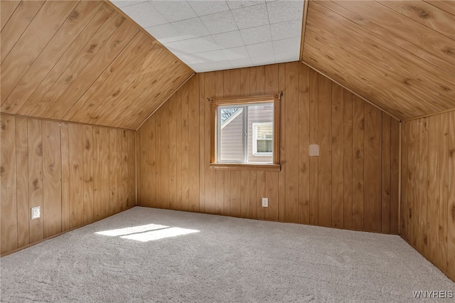 bonus room featuring wood ceiling, vaulted ceiling, wooden walls, and carpet