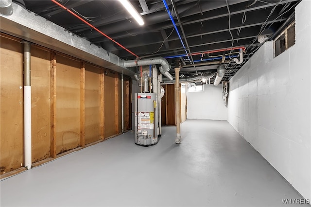 unfinished basement featuring water heater