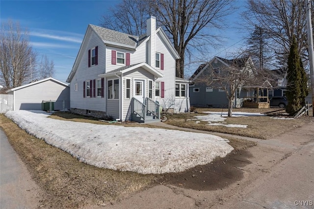 view of front of home with a chimney and a shingled roof