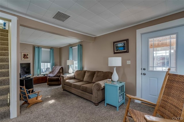 living room featuring stairs, carpet, visible vents, and a healthy amount of sunlight