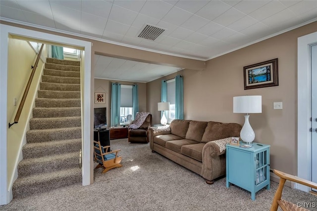 living area featuring visible vents, carpet, crown molding, and stairway