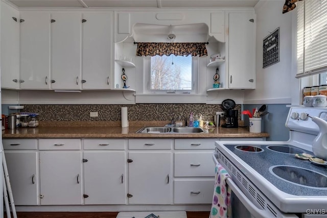 kitchen featuring decorative backsplash, open shelves, electric range, and white cabinets