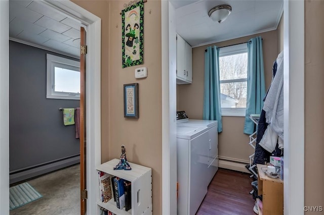 washroom with a wealth of natural light, washing machine and dryer, cabinet space, and a baseboard radiator