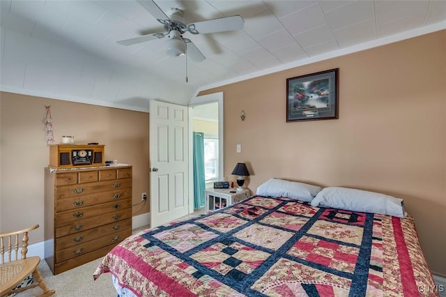 bedroom with lofted ceiling, a ceiling fan, crown molding, and carpet