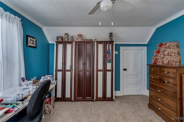 office area featuring a ceiling fan, vaulted ceiling, crown molding, and light colored carpet