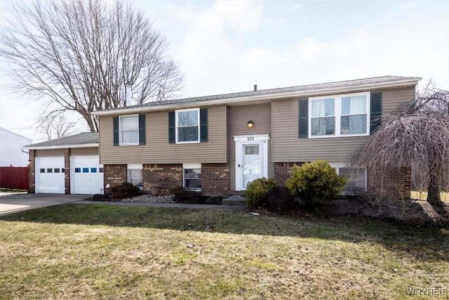 raised ranch featuring a garage, driveway, brick siding, and a front lawn