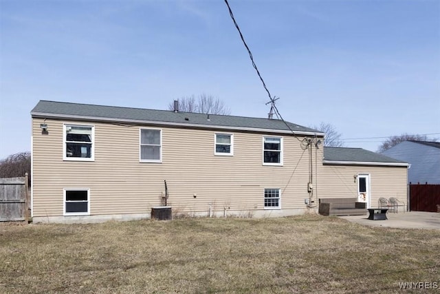 back of house with a patio area, fence, and a lawn