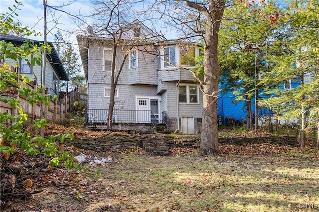 rear view of house with fence