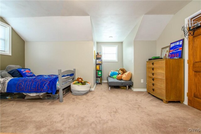 bedroom with baseboards, carpet, and vaulted ceiling