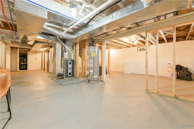 unfinished basement featuring heating unit and water heater