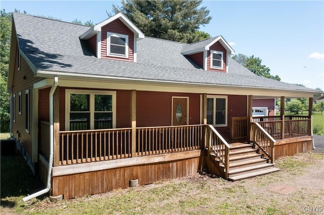 view of front of home with roof with shingles and a porch